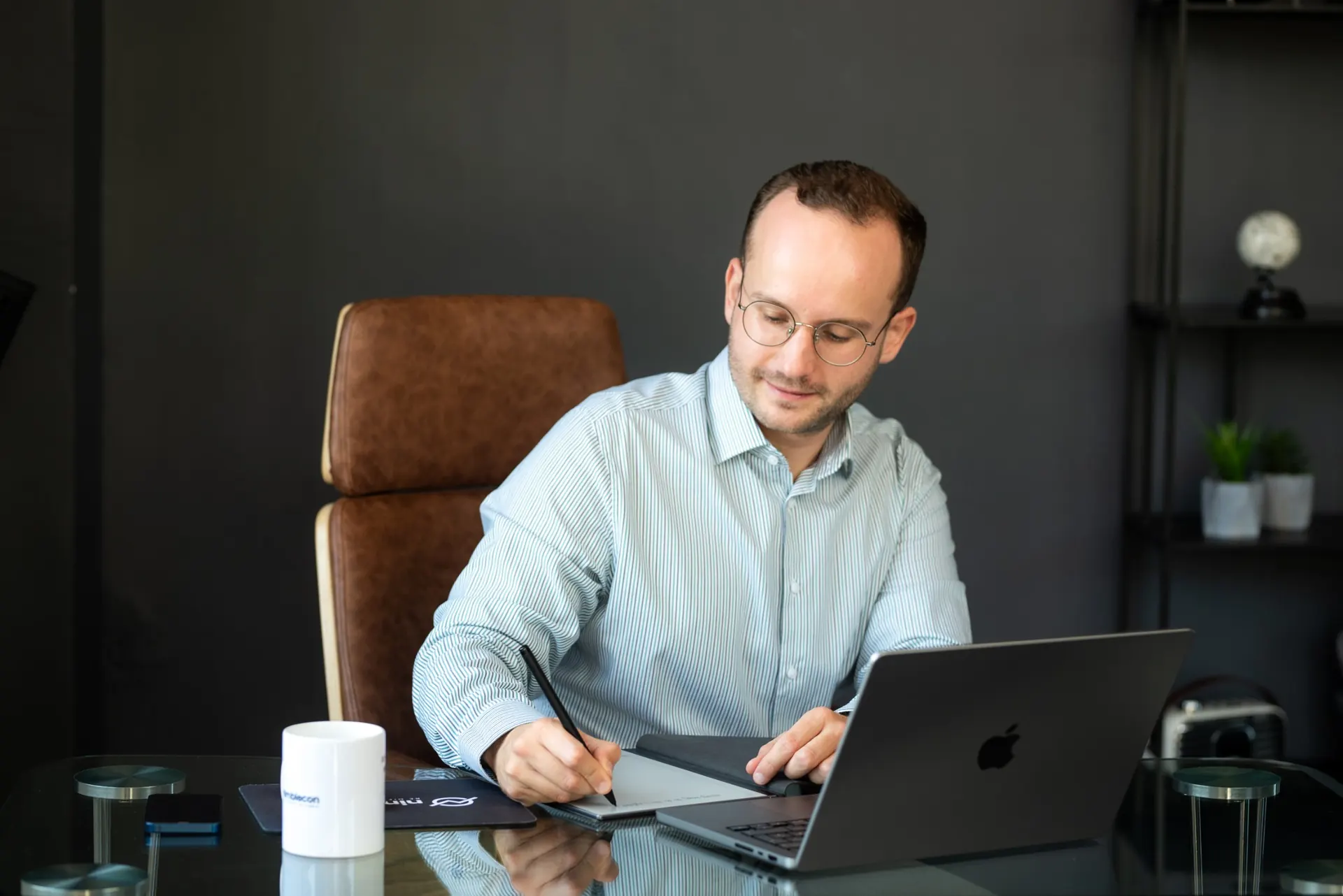 Milan Kölling taking notes at his desk
